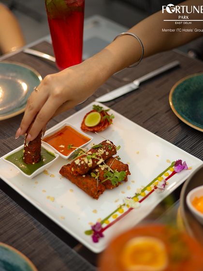 Our appetizers are as visually appealing as they are delicious. Here, a guest enjoys crispy rolls with our house-made dipping sauces.