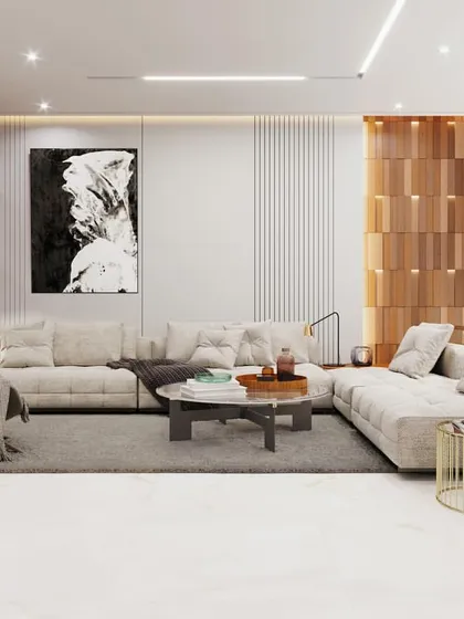 This living area combines modern design with spiritual elements, featuring a dedicated corner for a pooja space, seamlessly integrated with a custom wooden jaali screen. The open-plan layout is furnished with a plush sofa and contemporary art.