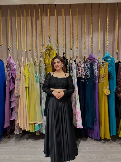 Another angle of the timeless black lehenga set. The full sleeves on the blouse provide good coverage while the cropped style keeps it modern. It is a versatile piece that can be styled in many ways.
