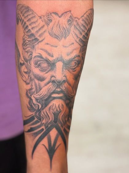This tattoo of a horned god figure showcases my skill in creating mythological and fantasy-based realistic portraits with deep shading.