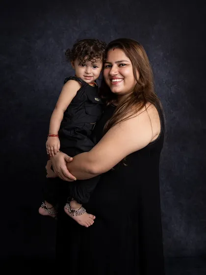 A simple and elegant portrait of a mother holding her child, showcasing their close bond.