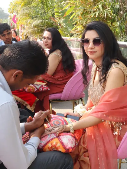 A guest getting her henna done. We ensure comfortable and pretty seating for guests during the Mehendi application.