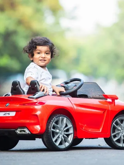Hitting the open road. This shiny red toy car is a fantastic prop that never fails to bring out the biggest smiles.