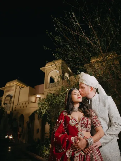 Sanjali and Eric share a quiet moment under the stars. We specialize in capturing the magic of the night, using architectural beauty and ambient light to create romantic, atmospheric portraits that feel both grand and personal.