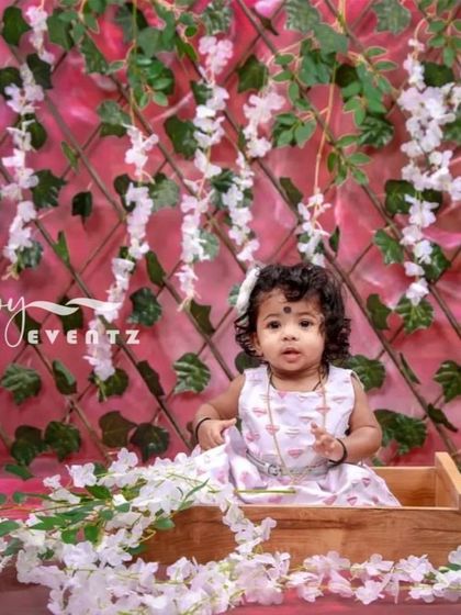 A delicate and beautiful Wisteria theme for a kids' photoshoot. The backdrop of cascading white flowers and green vines creates a magical, enchanted garden atmosphere for your little one.