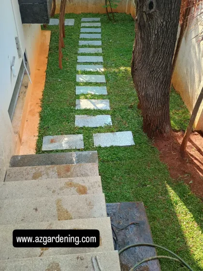 Another angle of the completed staircase garden, showing the clean lines of the path and the healthy green lawn.