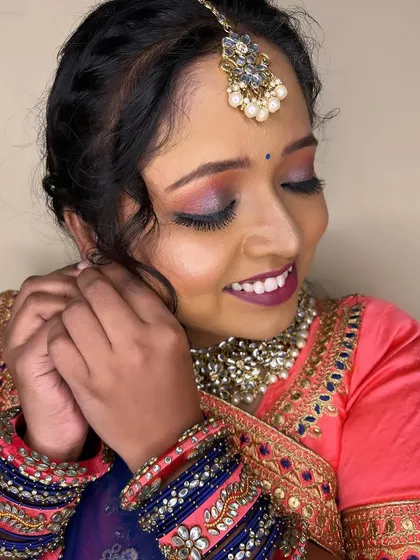 A sweet and candid moment. The makeup is soft and enhances her natural features, making her look effortlessly beautiful.