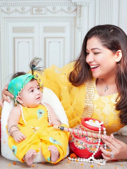A candid moment of laughter and play between a mother and her baby during our Janmashtami photoshoot.