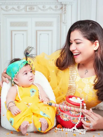 A candid moment of laughter and play between a mother and her baby during our Janmashtami photoshoot.
