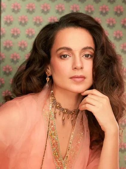 Kangana Ranaut looks absolutely elegant in this peach salwar suit from Raji Ramniq. The delicate embroidery and organza dupatta, paired with a traditional choker, create a look of timeless grace.