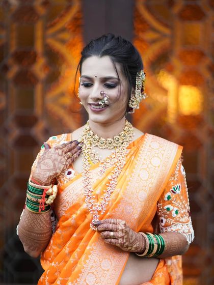 The bride, looking down with a gentle smile, a portrait of modesty and grace.