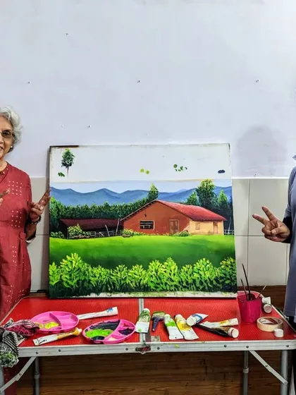 A proud moment for both student and mentor. Harinder ma'am and our instructor pose with her beautifully finished landscape painting before the exhibition.