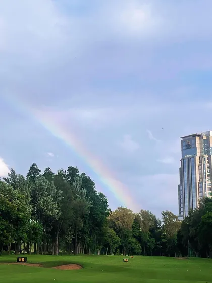 A rainbow arcs over the course after a brief shower. It’s a reminder of the beauty and unpredictability that makes every day of golf unique.