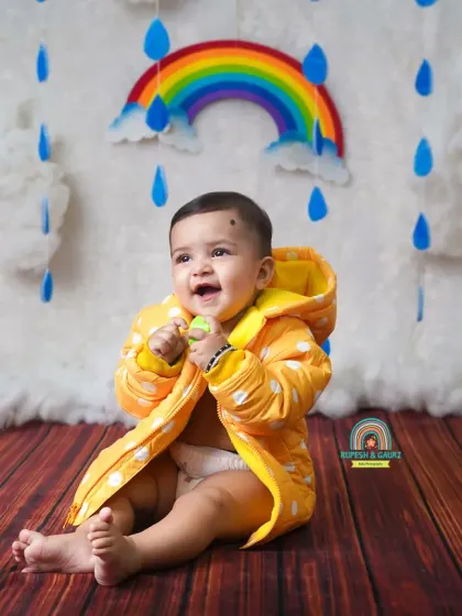 A big, cheerful laugh from this little one during our fun and colorful monsoon-themed mini session.