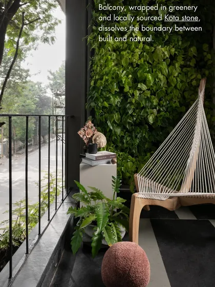 Our office balcony, wrapped in greenery and locally sourced Kota stone, dissolves the boundary between the built and the natural. This serene corner is a perfect example of our biophilic design approach.