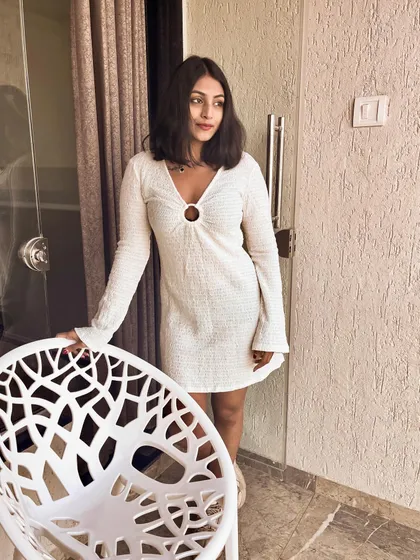 A full-length shot of the white dress. The keyhole detail at the neckline adds a subtle point of interest to this classic piece.
