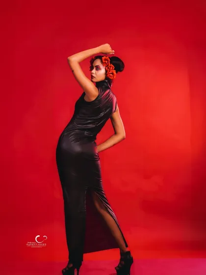 A classic fashion pose from the back, showcasing the fit of the dress and the model's strong posture.