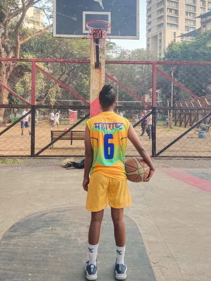 Wearing the Maharashtra jersey with pride. This shot from behind shows the name of the state she represents, a goal for many young players who join my basketball coaching programs.