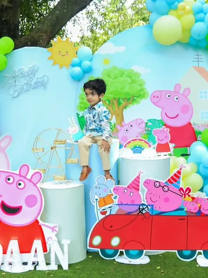 Oink oink! We transformed this outdoor space into Peppa Pig's world for a delightful 2nd birthday party. The setup featured large cutouts of the whole Pig family, a custom backdrop, and plenty of green and blue balloons to mimic a sunny day with Peppa.