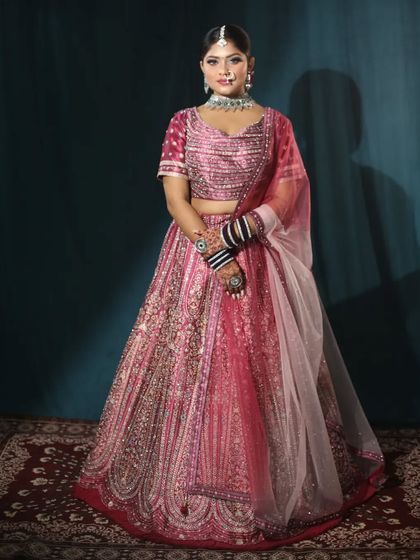 A simple, elegant pose in this pink bridal lehenga. I believe a bride's confidence is her best accessory, and my outfits are designed to provide just that.