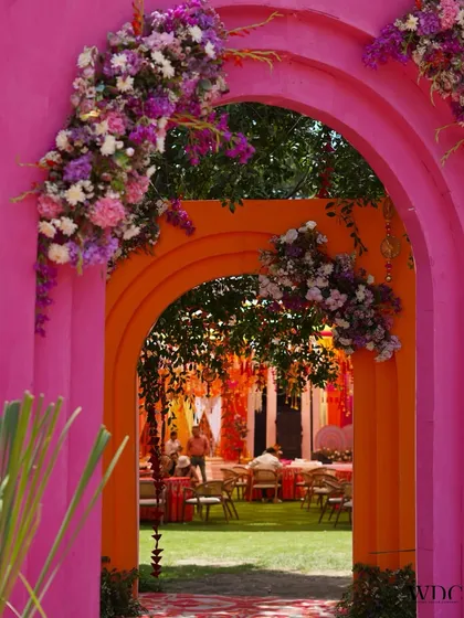 Haldi celebrations should be an explosion of joy and color. We crafted these vibrant pink and orange arches, adorned with lush floral arrangements, to create a picture perfect, fun-filled entrance that feels both festive and deeply personal.