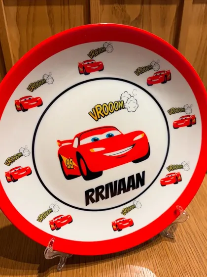 A close-up of our 'Cars' themed personalised plate. The bright colors and fun design are sure to make any meal more enjoyable.