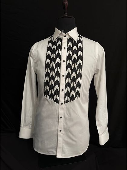 For a more modern and graphic look, I designed this white tuxedo shirt with a bold black-and-white chevron-patterned bib. It’s a statement piece that adds an artistic touch to your formal attire.