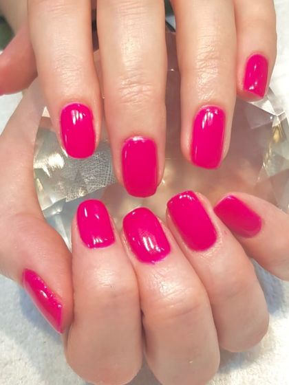 When in doubt, paint it pink. A vibrant, hot pink gel polish on natural nails for a fun and confident pop of color.