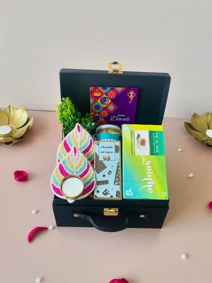 This view shows the thoughtful arrangement within the black suitcase box. It's a complete package with a festive card, making it a hassle-free yet personal gift.