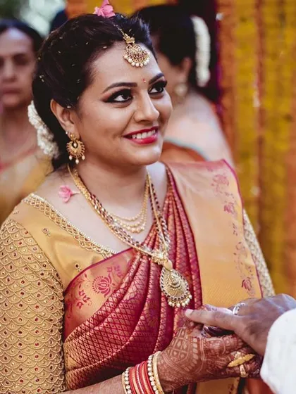 A beautiful, happy bride. We focused on creating a flawless base and defining her eyes, letting her natural joy shine through. This is a perfect example of a classic South Indian wedding look.