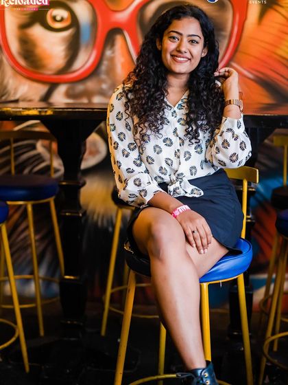 A guest sitting at the bar, with the venue's signature monkey graffiti in the background.