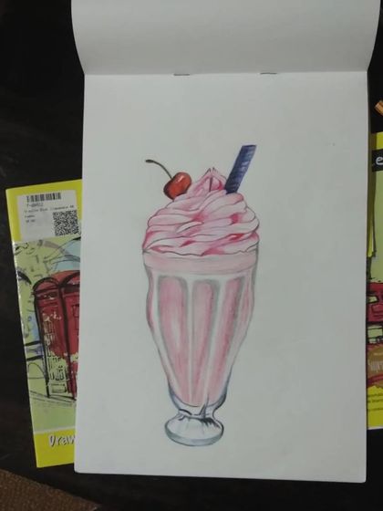 A finished drawing of a strawberry milkshake, done with color pencils. It looks good enough to drink.