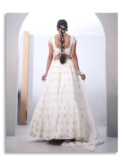 Understated does not mean underdressed. This white lehenga, with its subtle embellishments and flowing train, is a minimal and classic choice for a welcome brunch or post-wedding soirée.