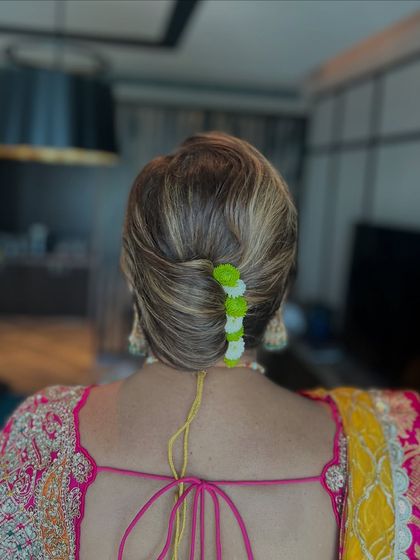 A modern French twist with a colorful floral accessory. This is a fun and stylish look for a mehendi or haldi ceremony.