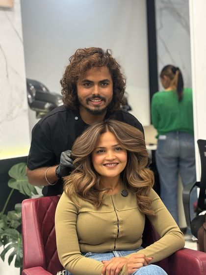 The client is all smiles with her new beach ash brown hair. The color and style perfectly frame her face.