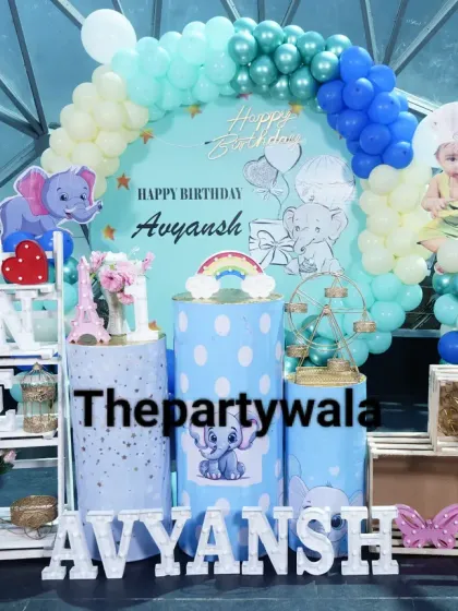 A cute baby elephant theme for a first birthday. The blue and white color scheme with elephant cutouts and themed pedestals is adorable.