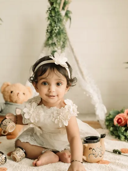 A close-up portrait of this adorable one-year-old, showing off her beautiful eyes and sweet expression.