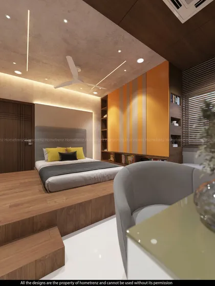 A unique kids' bedroom design with a raised platform bed. The orange and grey color scheme is modern and playful, and the built-in desk and shelves are highly functional.