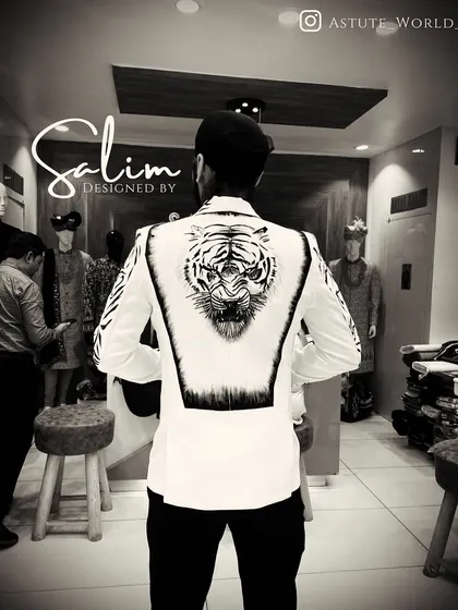 A custom white blazer with a hand-painted tiger design on the back. The black and white artwork creates a striking contrast, perfect for making a memorable entrance.