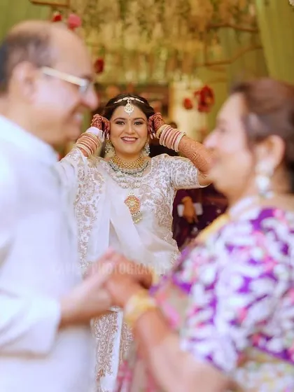A beautiful, candid moment between the bride and her parents, filled with emotion and love.