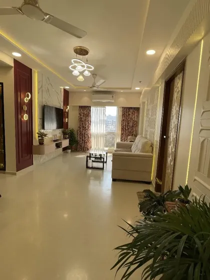 I design open, flowing spaces where life can unfold beautifully. This expansive living and dining area combines modern luxury with comfortable living, featuring a rich color palette, statement lighting, and custom wall textures to create a truly impressive and welcoming atmosphere.
