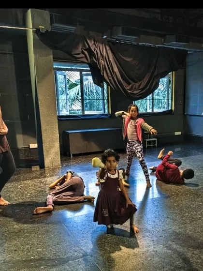A candid shot from a children's theatre rehearsal. You can see the raw energy and imagination at play as they explore characters and scenes.