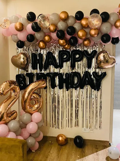 A full view of the sophisticated birthday photo corner, combining metallic, pastel, and black balloons for a modern look.