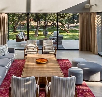 Natural light is our most valued material. In the Mango Orchard House, we designed the living area with expansive glass walls that frame the lush greenery, making the landscape an integral part of the daily living experience.