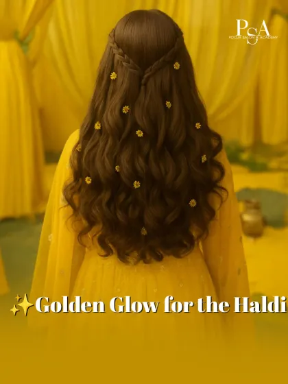 A soft, open hairstyle with loose waves and delicate floral details. This look is perfect for a Haldi ceremony, offering a fresh and youthful vibe that feels effortlessly beautiful.