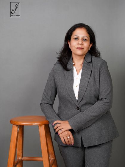 Using a stool as a prop, this pose creates a slightly more relaxed feel while maintaining a professional look.