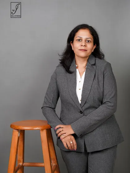 Using a stool as a prop, this pose creates a slightly more relaxed feel while maintaining a professional look.
