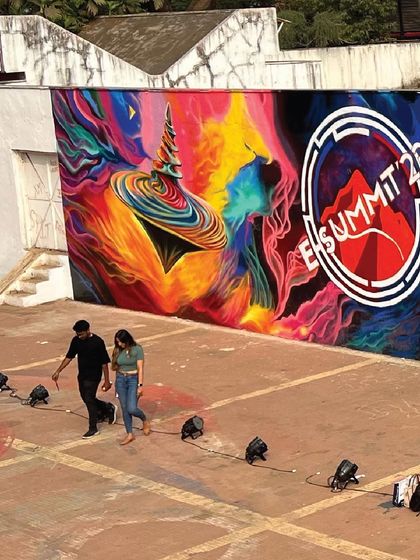 A wide shot of the completed 'Space Mining of Dreams' mural for the E-Summit at IIT Bombay. The artwork served as a powerful, inspiring backdrop for the entire event.