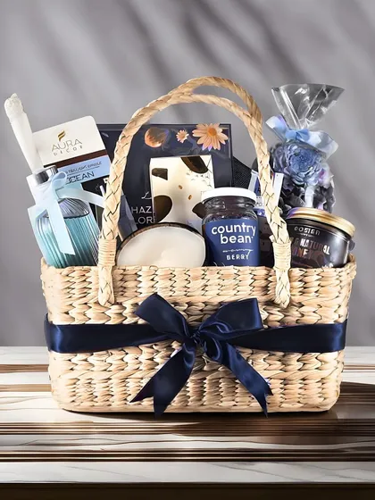 Our curation goes beyond the standard gift box. This beautifully arranged Diwali hamper in a rustic woven basket is filled with premium goodies and tied with a navy blue ribbon, showcasing a different style of elegant presentation.