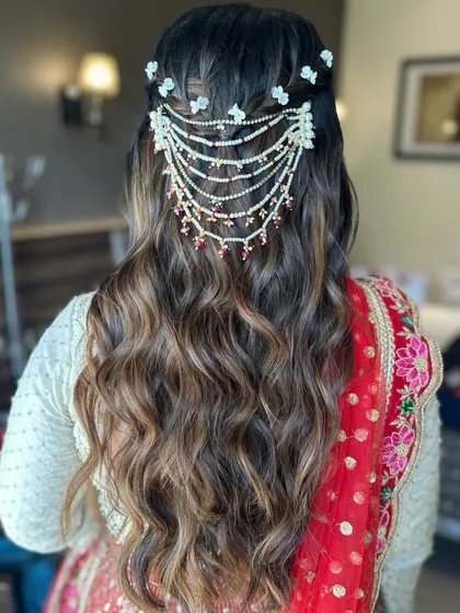 A beautiful hairstyle for a pre-wedding ceremony, featuring intricate braids and a stunning hair accessory.